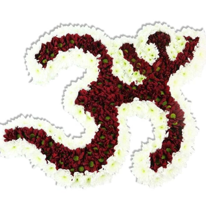 A meticulously hand-built Om (Aum) symbol formed entirely from flowers rests against a clean white background, its lines rendered with the steady eye of an experienced florist. The symbol's body is composed of tightly clustered, small-headed chrysanthemums in a saturated maroon to deep red, each bloom showing a tiny lime-green centre that gives the dark mass a whisper of freshness and natural variance. Surrounding and tracing the character's interior and exterior contours is a thick, flowing border of immaculate white spray chrysanthemums, the contrast between the white rim and the red interior making the '3' curve, the descending rounded stroke, and the upper tilde unmistakable. The arrangement has a sculptural presence-lush, compact, and soft-eyed-while a delicate drop shadow beneath it asserts three-dimensionality, as if it had just been lifted from a preparation table at our shop. The petals appear cool and silky; the overall fragrance is a gentle, earthy chrysanthemum note that calms rather than overwhelms. Having created similar devotional pieces for services and cultural events around Epping High Street and near the forest edge, I imagine this work placed on a ceremonial plinth or beside a shrine for quiet, communal observance. This version is what we might craft at Flowers Epping when a family requests a meaningful, locally made tribute that balances artistry with reverence-an image of devotion shaped in colour and texture, offering solace and a dignified visual focus for spiritual gatherings or memorial remembrances.
