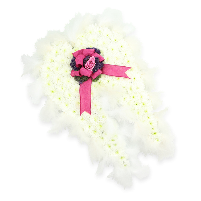 A beautifully sculpted floral angel wing tribute is displayed against a spotless white backdrop, allowing its refined craftsmanship to stand out clearly. The entire wing shape is dense with tiny white flowers, most likely chrysanthemums or similar small-headed blooms, each one placed so closely that they merge into a smooth, velvety surface, like a cloud drifting above the fields on the edge of Epping. Subtle touches of light green at the centres of the flowers lend gentle variation and keep the design looking fresh and lifelike rather than flat. Tracing the full sweep of the angel wing, from tip to base, is a halo of soft white feathers, their edges slightly ruffled as if caught in a faint breeze, enhancing the impression of lightness, purity, and spiritual protection. At the upper central point of the wing, a vibrant fuchsia-pink satin ribbon is fashioned into a full bow, its glossy loops and trailing ends resting across the floral surface with elegant ease. Nestled into the heart of the bow is a flawless pink rosebud, its spiralled petals hugging close, symbolising love held gently but firmly in the memory. Just beneath the rose, a cluster of deep purple, almost blue-toned thistle-like flowers or textured foliage provides a rich accent of colour and a hint of wild hedgerow charm, reminiscent of walks around the lanes between Epping and Theydon Bois. The finished tribute offers a serene and uplifting presence, ideal for a funeral or memorial service, and captures the kind of thoughtful, personal workmanship you might expect from a long-established Epping florist, creating flowers that speak softly when words are hard to find.
