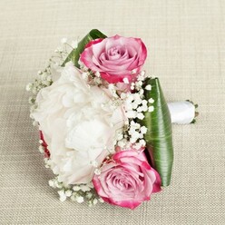 Gently resting atop a textured, natural linen reminiscent of Epping's homely charm, this thoughtfully composed bouquet evokes a sense of intimacy and artistry. The arrangement features two prominent pink roses-one positioned at the top-left, another at the bottom-right-each opening in a beguiling spiral of fuchsia-edged petals blending to subtle blush and lavender centers, echoing the ever-changing hues of Epping Common in spring. At the heart sits a billowy white peony, its ruffled petals unfolding in creamy abundance, creating a plush oasis among the surrounding blooms. Airy clusters of gypsophila, or baby's breath, add a constellation of pure white detail, their cloud-like texture softening the overall silhouette. Broad, deep green tropical leaves wrap the base, framing the bouquet and lending a contrasting vibrancy reminiscent of Epping's leafy canopies. The hand-tied stems, bound neatly with a pristine white satin ribbon, extend gracefully to the side-ready to be held by a bride or bridesmaid in a celebration at one of Epping's beloved local venues. Illuminated with gentle, even light, every petal and leaf reveals its intricate beauty, embodying themes of romance, new beginnings, and the artisanal touch that defines floral creations from Flowers Epping.
