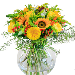 A bouquet inspired by Epping's late summer landscapes, bursting from a round glass vase like radiant sunshine woven into flowers. At the heart, majestic sunflowers invite the eye with their dark, textured centers and vivid yellow petals, opened as if greeting a morning near the High Street. Flanking them, yellow garden roses spiral gracefully, velvet-soft and deeply layered, exuding nostalgia and effortless beauty. Among these golden blooms, glossy red Hypericum berries sparkle-like scattered gems-against a luxuriant backdrop of feathery ferns and trailing greens reminiscent of walks in the Lee Valley. Hints of goldenrod and solidago add delicate sprays of tiny blossoms, while slender green spikes and elegant eucalyptus leaves contribute freshness and gentle fragrance evoking the air just after rainfall on Stonards Hill. The clear, bowl-shaped vase pools light below the vibrant stems, grounding the composition in clarity and reflecting the crispness of local Epping mornings. This arrangement is both an invitation to gather and a tribute to openhearted moments-a centerpiece ready to transform a kitchen table, convey heartfelt wishes to someone on a birthday, or simply infuse a living space with hope and cheer. Every element has been thoughtfully chosen by a local florist, reflecting the natural charm and welcoming spirit of Epping in every curve and hue.