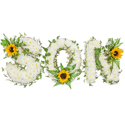 A carefully composed sympathy tribute reads SON in strong capital letters, each letter sculpted from hundreds of immaculate white chrysanthemums that create a plush, tactile surface. The white chrysanthemums sit close together, their tiny petals overlapping like a soft quilt, and are threaded with trailing dark-green ivy whose five-pointed leaves and wiry stems loop and curl through the composition, suggesting resilience and the steady passing of seasons. Sprays of feathery fern and crisp green foliage sit beneath and between the letters, lifting the white mass with fresh, cool tones. Bright yellow sunflowers punctuate the arrangement with three joyful focal points - one tucked into the upper left curve of the S, one placed at the bottom curve of the O where it catches the eye, and one resting on the upper right of the N - each sunflower showing broad, golden petals around a textured, dark brown centre that adds warmth and a tender counterpoint to the bereavement palette. The entire piece is photographed against a stark white backdrop so the textures - the chrysanthemums' velvety heads, the ivy's glossy sheen and the sunflower's coarse centre - are visible and immediate. As experienced florists serving Epping and the surrounding villages, we at Flowers Epping craft tributes like this for funerals and memorials, balancing purity, life and light to honour a beloved son with dignity and heartfelt care.