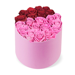 As a local florist with a heartbeat for Epping's neighborhoods, I read this two-tone rose box as modern romance translated into bloom. The top red arc forms a sophisticated crescent at the box's crown, embraced by a field of bright fuchsia roses below, all arranged in a soft pink velvet hatbox that feels tactile and refined. The roses are fully opened, their petals curling in gentle spirals that catch the light, creating depth and a creamy, velvety texture. The design is clean and intentional-stems spaced with care to convey abundant beauty without crowding-set against a crisp white backdrop that makes the colours sing. The scent is delicate and uplifting, a quiet invitation to celebrate a moment-Valentine's, an anniversary, or a meaningful new chapter. For delivery across Epping and into neighbouring towns like Loughton and Chigwell, this bouquet offers both striking aesthetics and dependable freshness. It's the kind of arrangement Flowers Epping would curate for a thoughtful surprise, a gift that asks the recipient to pause, smile, and feel cherished.