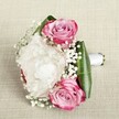 Imagine the gentle hush of a morning in Epping, where this delicate bouquet graces a light, textured linen-its palette a harmonious whisper of romance and celebration. Centered by a voluminous white peony, each ruffled petal catches the soft glow of natural light, radiating an airy elegance. Flanking this bloomscape, two pink roses unfurl in vibrant gradients-outer petals tinged in passionate magenta, melting into soft blush and lavender hues at their heart-each swirl brimming with hope and anticipation. Wisps of baby's breath float through the design, their tiny white blossoms lending a fairy-tale delicacy, akin to springtime wildflowers along the Epping outskirts. The base, wrapped in deep green, sleek tropical leaves, gives structure and a bold counterpoint to the pastel grace above. Held together by a crisp white satin ribbon, the bouquet's handle is both classic and comforting, suggesting the trusted hands of a local florist. The full composition glows with quiet celebration and refined craft, inviting memories of vows exchanged at woodland venues or intimate garden ceremonies in Epping. This bouquet is not only an emblem of love but also a testament to the town's enduring beauty and the thoughtful artistry of Flowers Epping's team.