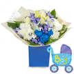 A jubilant, hand-styled presentation that reads like a lullaby in colour and texture: a round, abundant bouquet spilling from a matte royal blue rectangular gift box, photographed against a crisp white background. At the centre, creamy white roses form a soft, pillowy heart, their petals reflecting a cool, morning light; nearby slender white lilies stand poised-some just unfurling in pale ivory, their long stamens hinting at a faint, sweet pollen scent that lifts gently from the arrangement. Fluffy white chrysanthemums give the composition depth and a comforting weight, while clusters of electric blue chrysanthemums and a concentrated group of vivid cobalt blooms create a dramatic, joyful focal point that affirms the newborn-boy theme. Interspersed among them are delicate lavender-periwinkle sprays-tiny bell-shaped florets that suggest hyacinth or similar spring blooms-adding powdery texture and a soft fragrance that curls through the greens. Lush foliage, from broad glossy leaves to feathery fern fronds, frames each blossom and introduces cool, verdant contrast. The bouquet is gathered in crinkled, translucent cream paper at the base, the tactile folds catching the light and softening the presentation. To the right, a light-blue foil balloon shaped like a vintage baby carriage floats slightly, its canopy and wheels traced in deeper blue with playful polka dots and hearts; across the body, a cheerful It's a Boy in yellow-green lettering makes the occasion unmistakable. This set-flowers, box, and balloon-feels made for a hospital visit, a baby shower, or a welcoming-home moment, radiating warmth, celebration, and the delicate optimism of new life for families in and around Epping.
